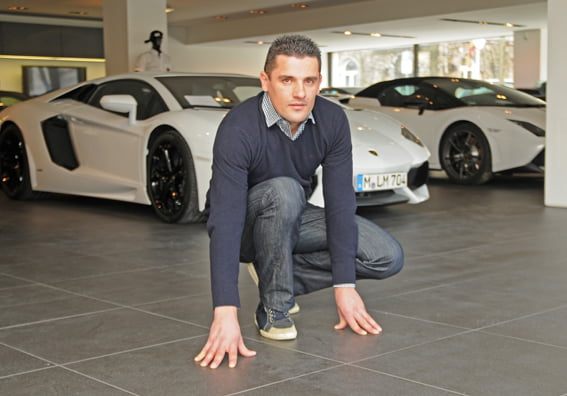 Mario Karacic, Inhaber mk fliese & stein gmbh, prüft die Bodenverlegung im Showroom von Lamborghini München